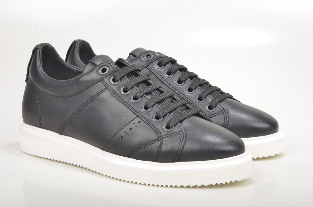 Black leather sneakers with laces, side view