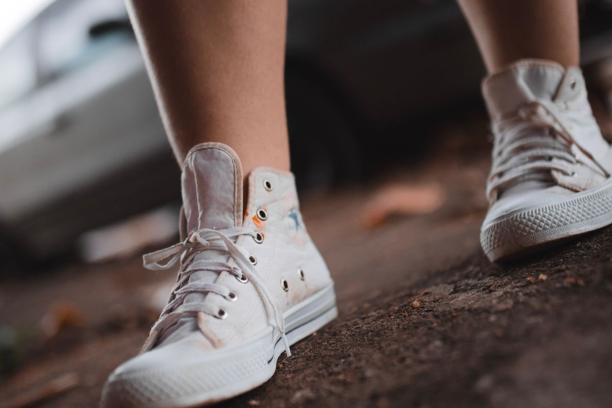 A pair of white sneakers resting after a long walk