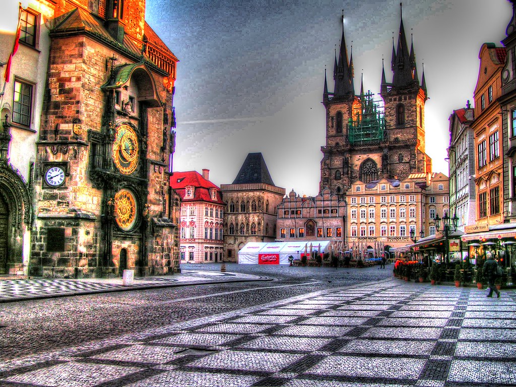 An old town square in the evening with people walking