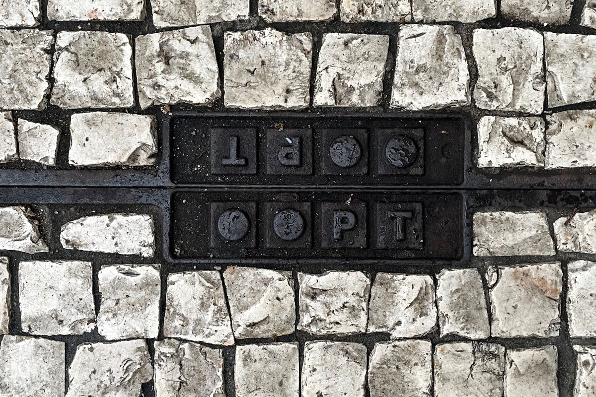 Cobblestone sidewalk with embedded metal plates underfoot
