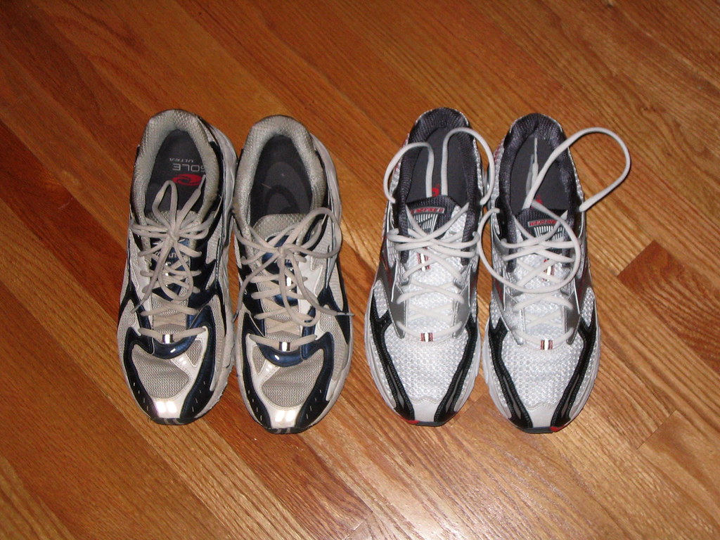 The worn soles of a pair of running shoes